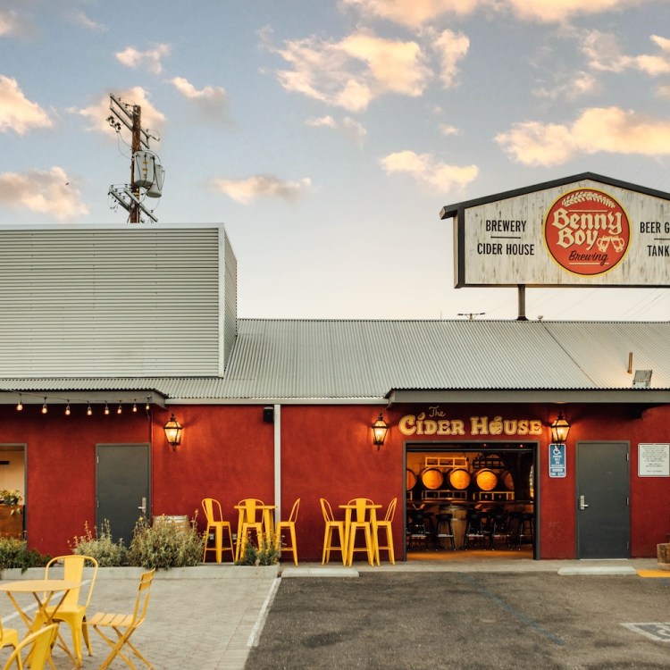 red barn with sign and lights, yellow chairs outside