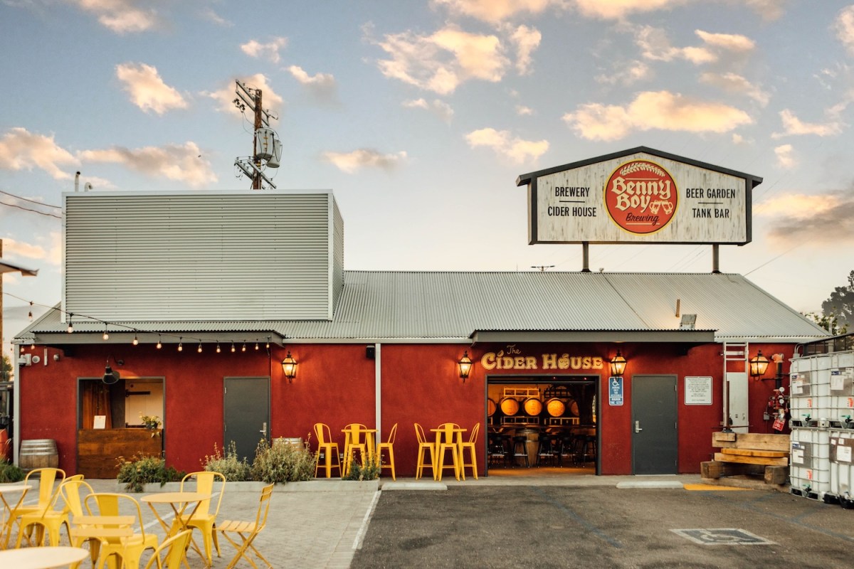 red barn with sign and lights, yellow chairs outside