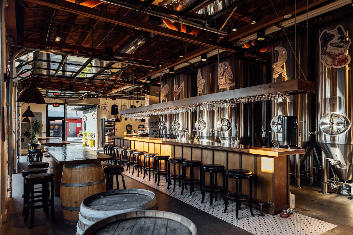 inside of bar with stools, barrels, wood