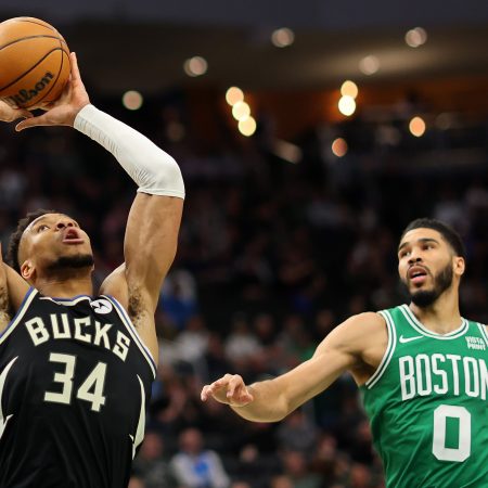 Giannis Antetokounmpo is defended by Jayson Tatum.