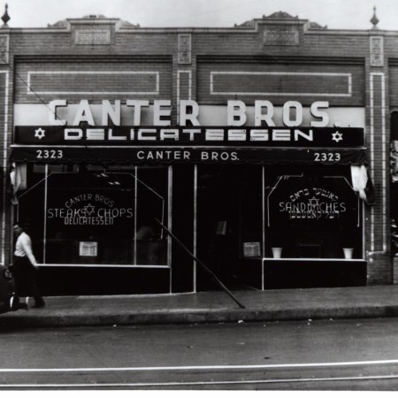 black and white vintage photo of restaurant front with sign