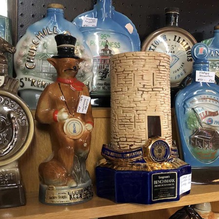 A shelf of vintage bourbon decanters