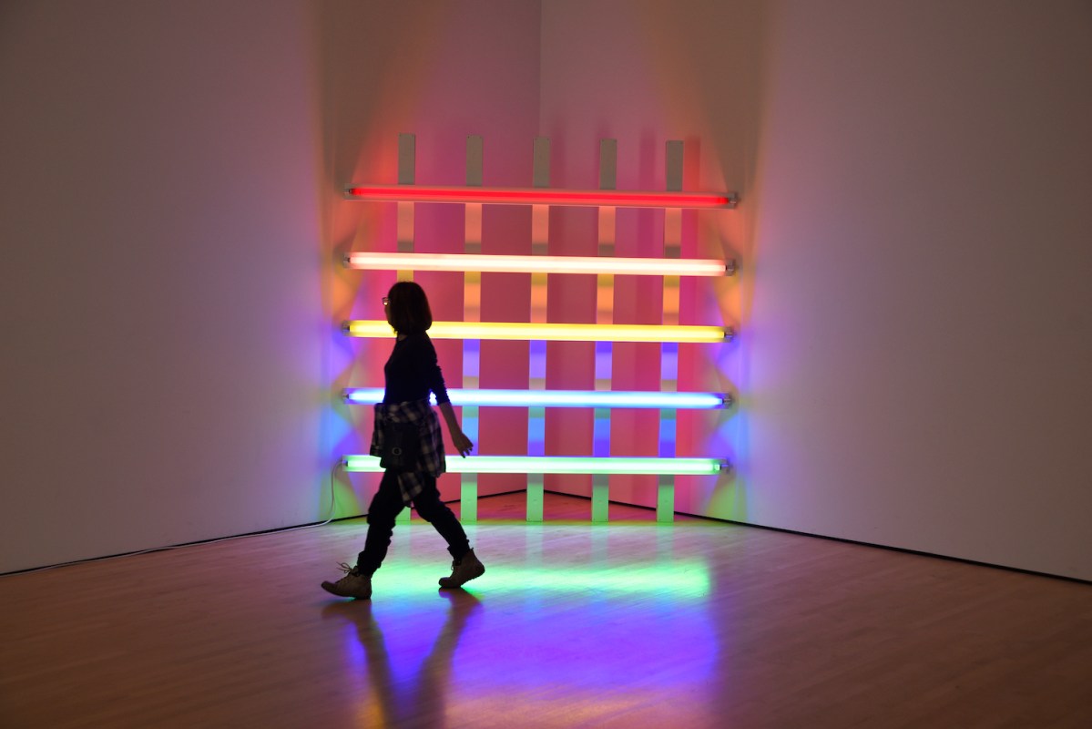 A museum visitor admires a neon sculpture by Dan Flavin at the San Francisco Museum of Modern Art in San Francisco, California