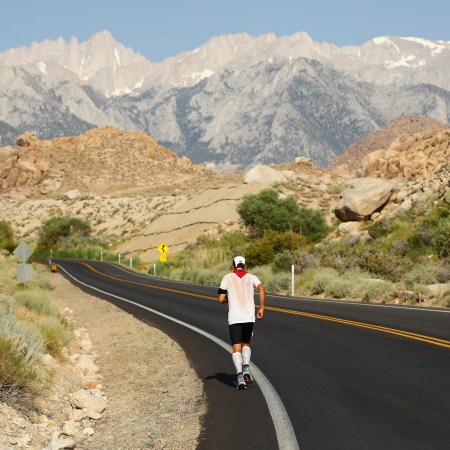 A man running on the road in the heat.