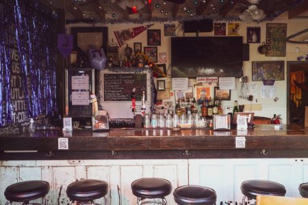 Barstools lined up at a decorative bar.