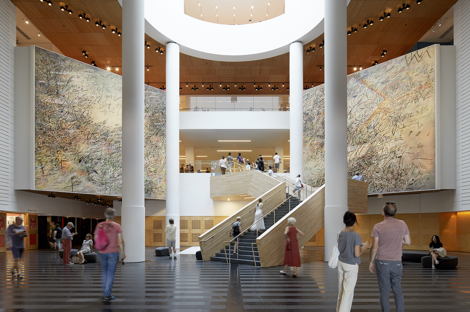 people standing and walking in the lobby of SFMOMA