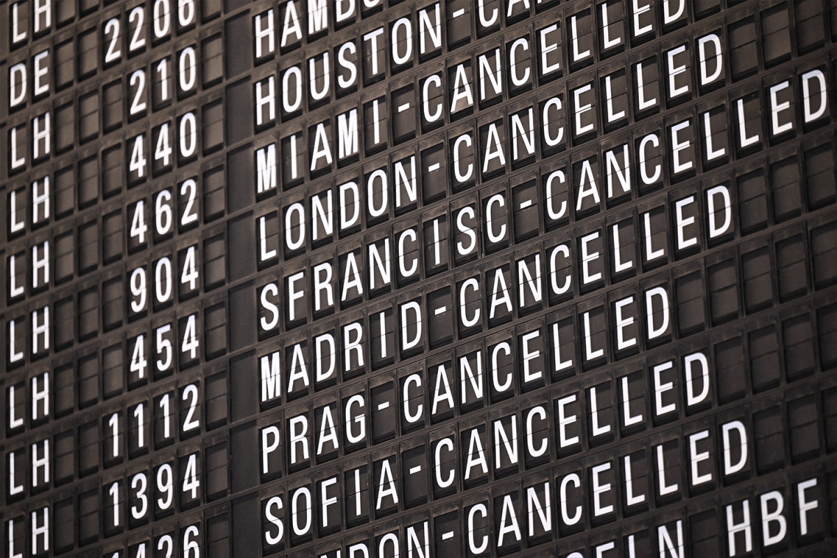 A departure and arrivals board at an airport showing a bunch of canceled flights